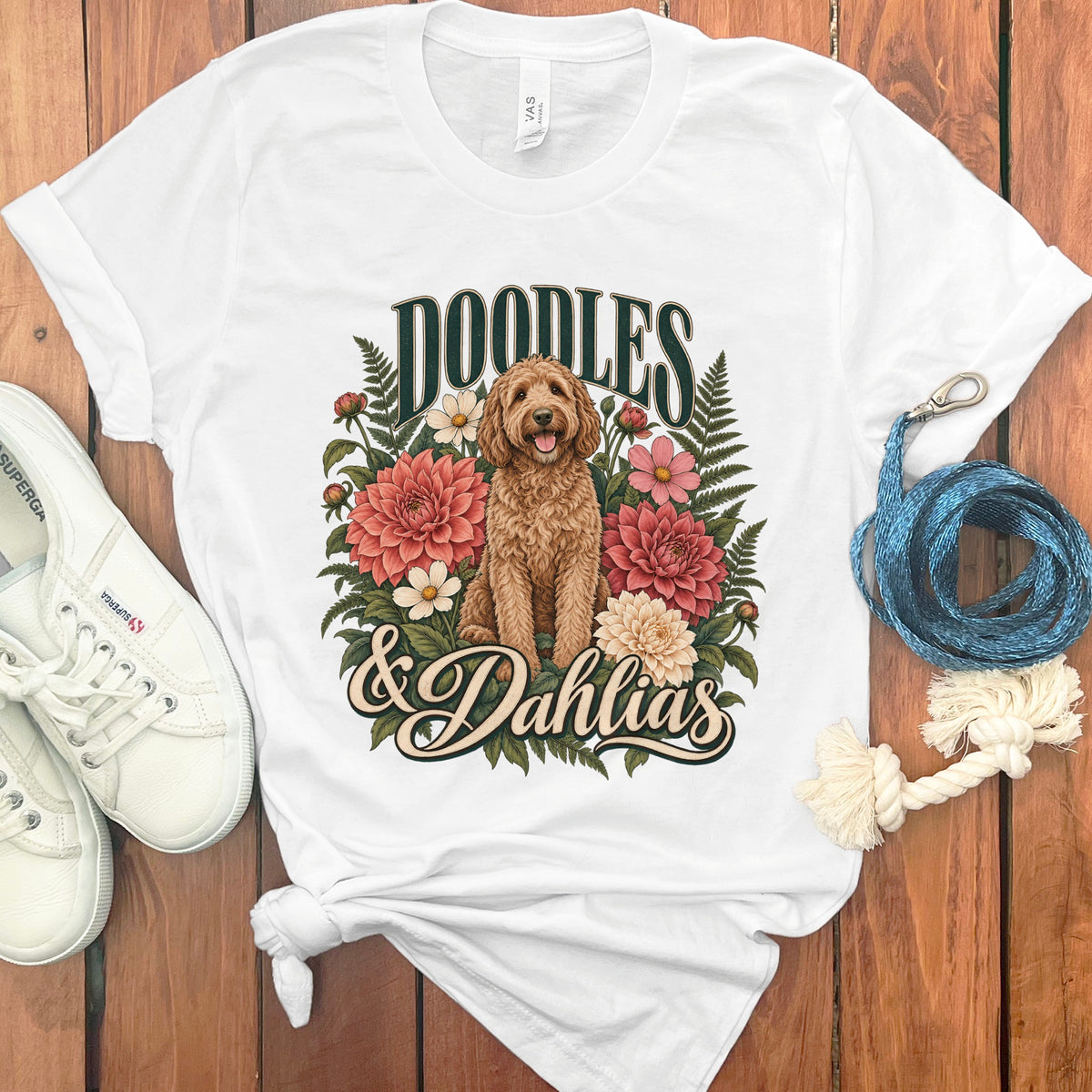 White t-shirt with a brown doodle dog and flowers, saying "Doodles & Dahlias".