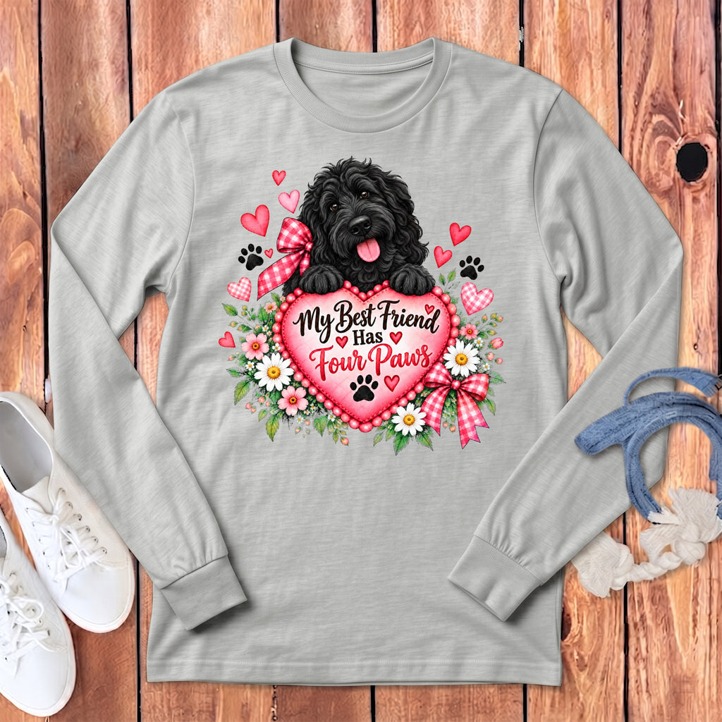 A grey long-sleeve shirt featuring a black dog, flowers, and the text My Best Friend Has Four Paws on a pink heart.