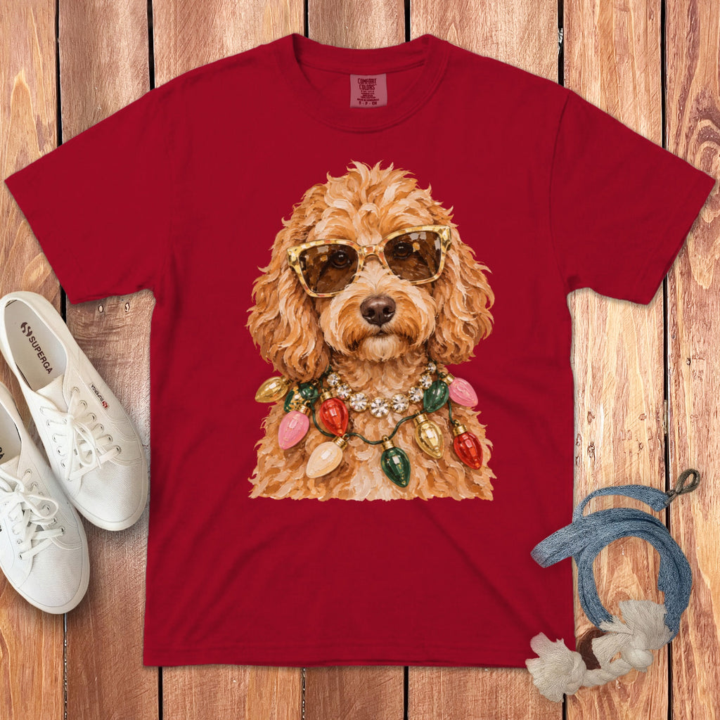 Red t-shirt with a doodle wearing sunglasses and a Christmas light necklace.
