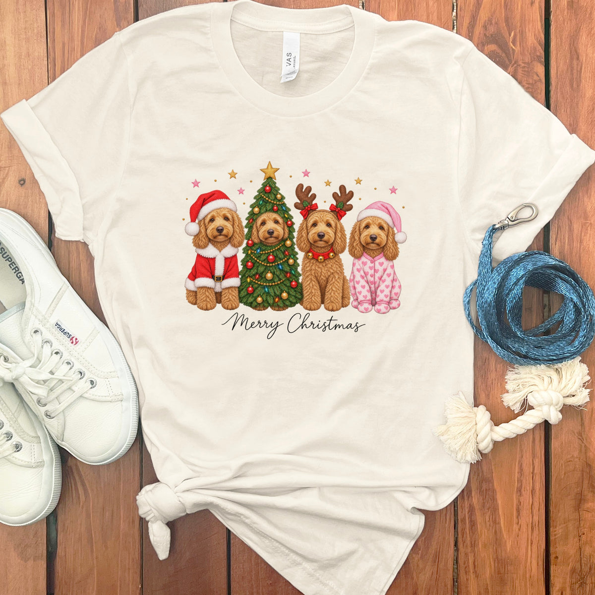 Cream crewneck t-shirt featuring a Christmas graphic of four goldendoodles, a decorated tree, and Merry Christmas text.