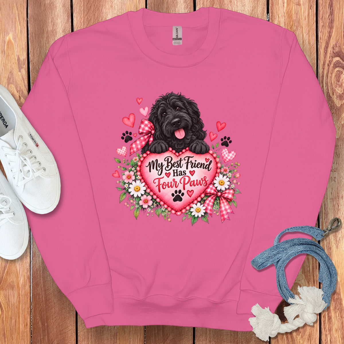 Pink crewneck sweatshirt with a graphic of a black dog, flowers, hearts, and text reading My Best Friend Has Four Paws.