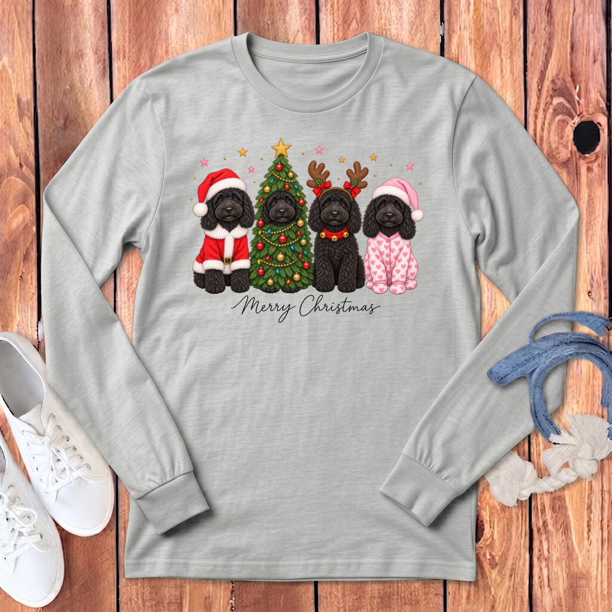 Gray long-sleeve t-shirt featuring four black doodles celebrating Christmas with a decorated tree and text.