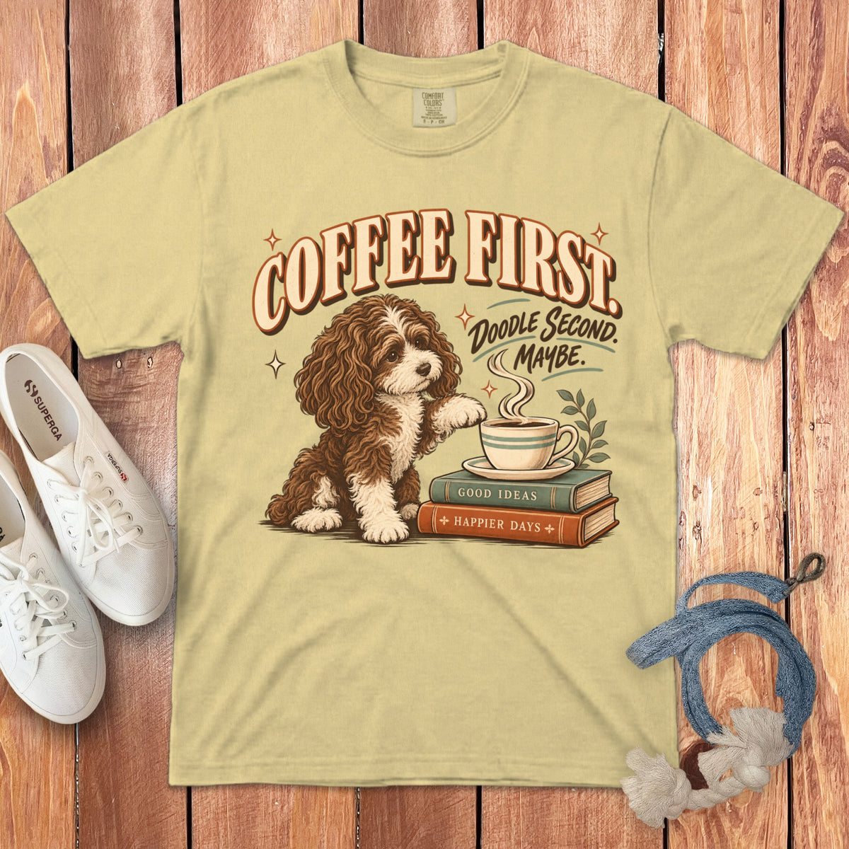 Light yellow t-shirt featuring a brown and white doodle dog with books, coffee, and retro text.