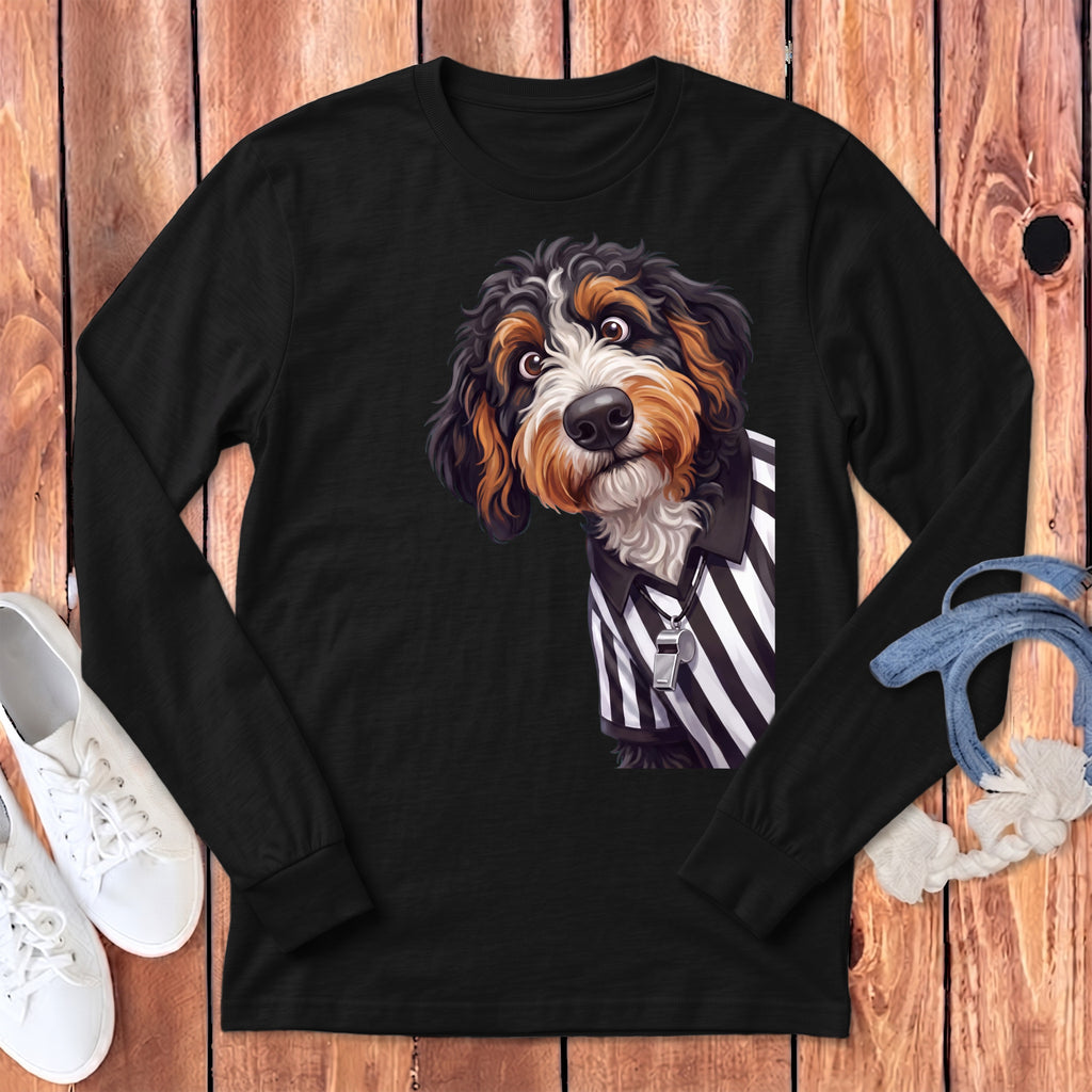 Bernese Mountain Dog in referee uniform with whistle on black long-sleeve shirt.
