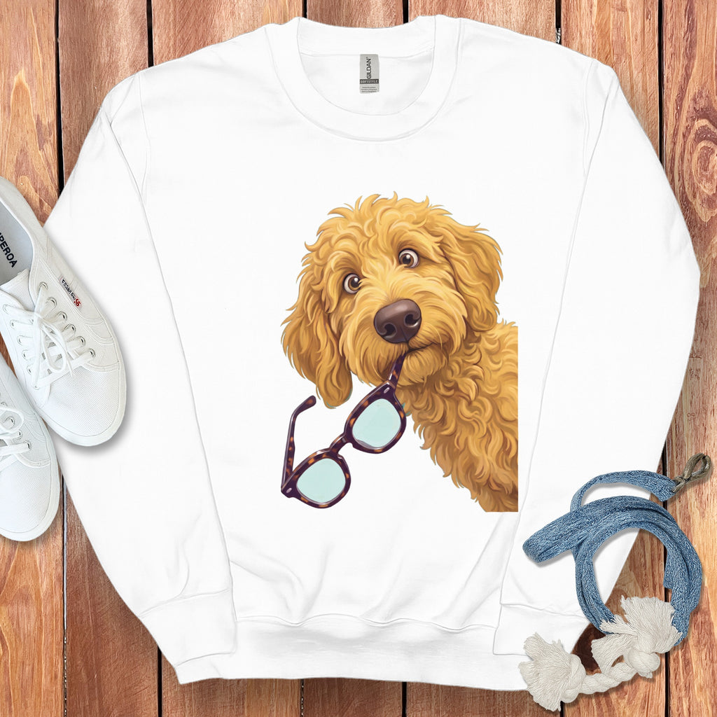 White crewneck sweatshirt featuring a graphic of a golden doodle dog holding tortoiseshell glasses in its mouth.