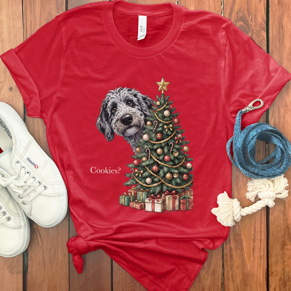 Red t-shirt with a dog peeking from behind a decorated Christmas tree.
