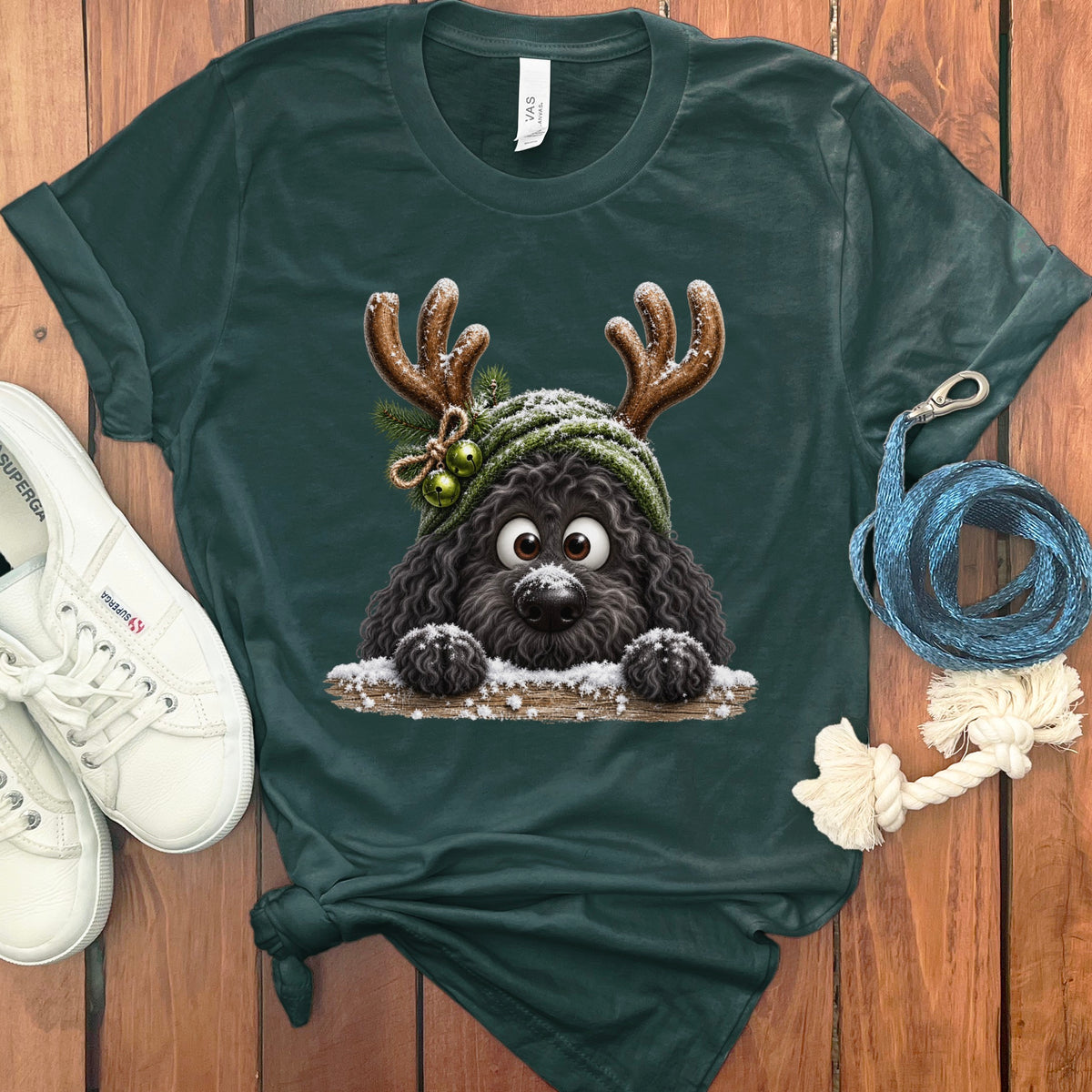 Dark green t-shirt with a cartoon black dog wearing reindeer antlers and a hat.