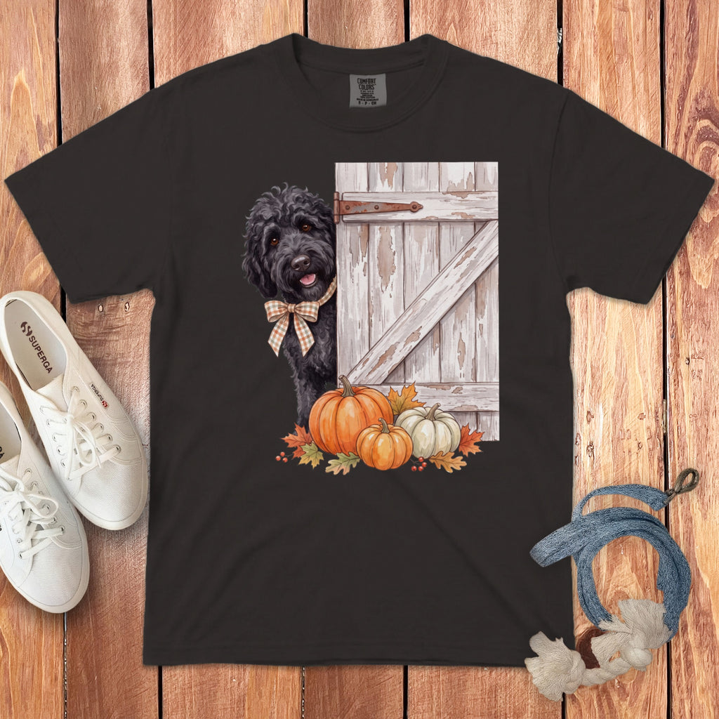 Black t-shirt with black doodle dog, barn door, pumpkins, and autumn leaves graphic.