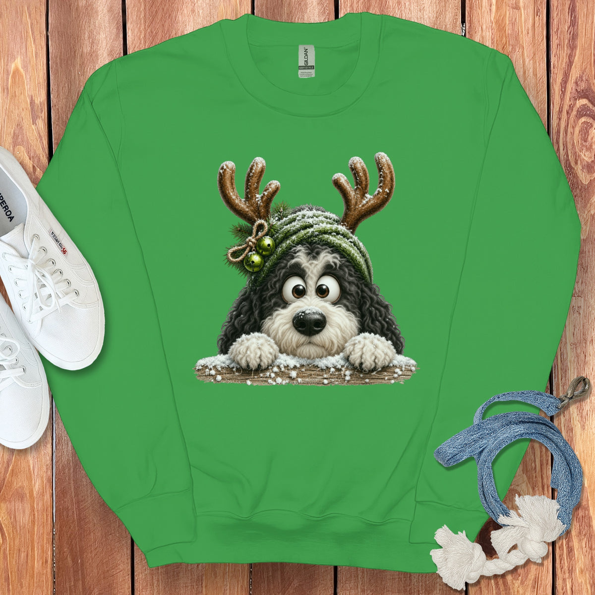Green sweatshirt with a cartoon dog wearing reindeer antlers and a knitted hat.