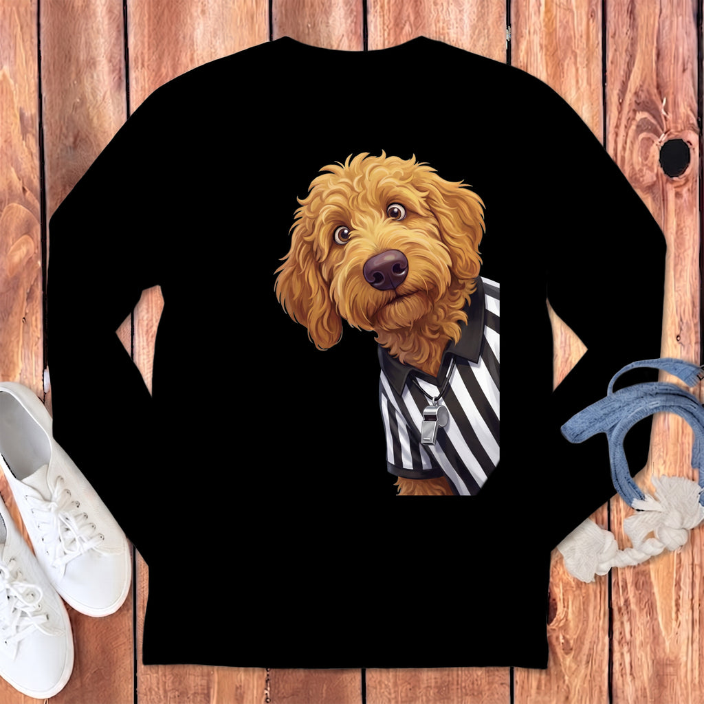 Golden doodle dog wearing a referee shirt and whistle on a black long-sleeve shirt.