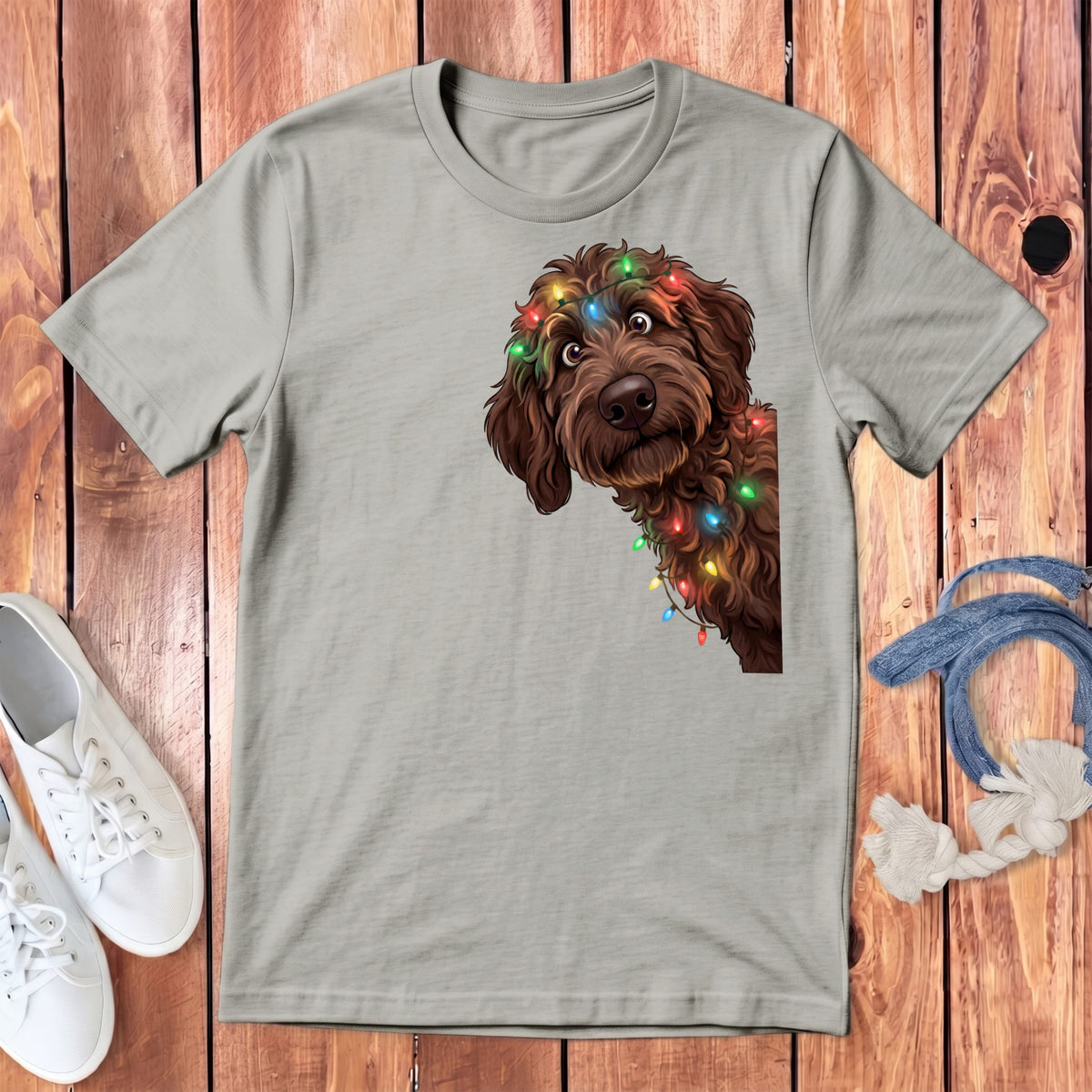 Light grey t-shirt with brown dog wearing colorful Christmas lights graphic.