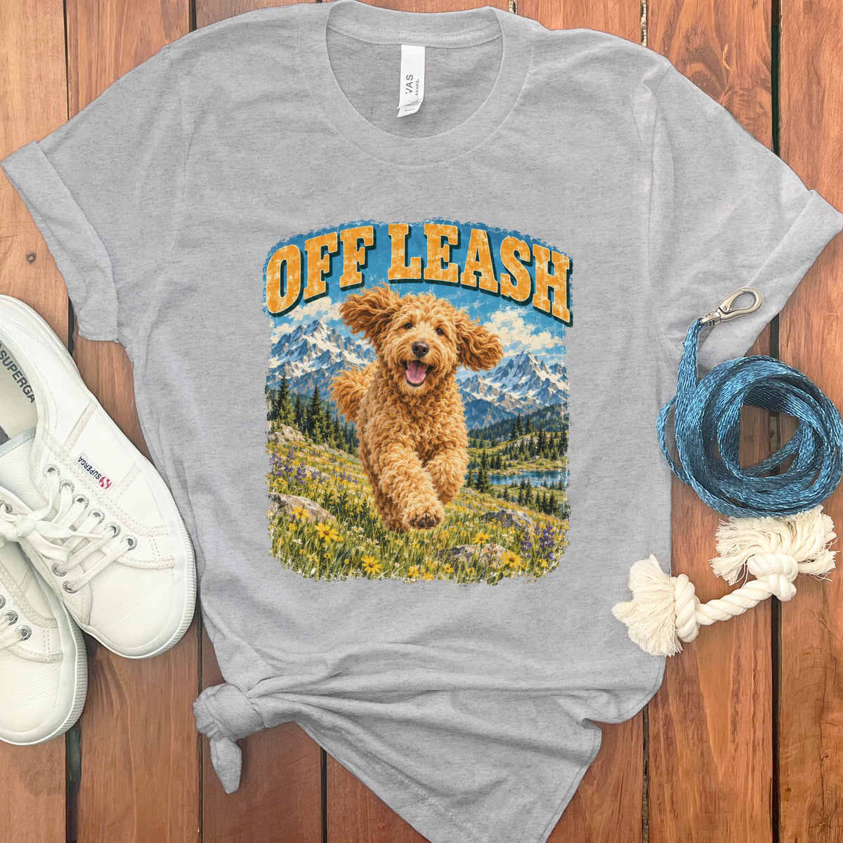 Grey t-shirt with "OFF LEASH" graphic featuring a happy dog running in a mountain landscape.