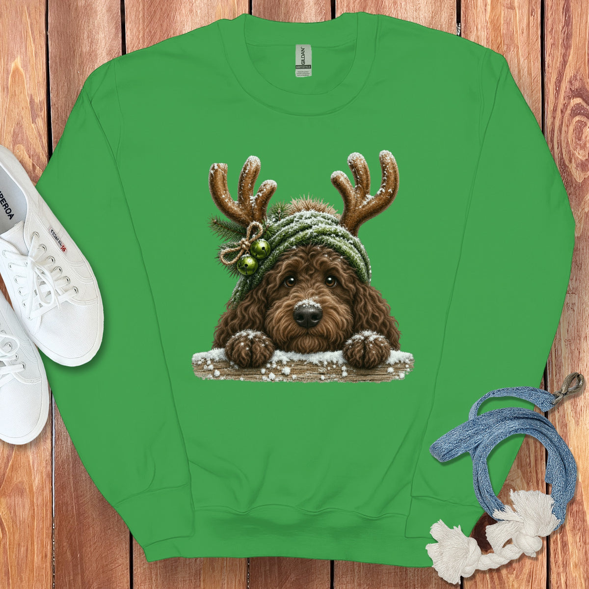 Green sweatshirt with a brown dog wearing antlers and a green hat with bells.