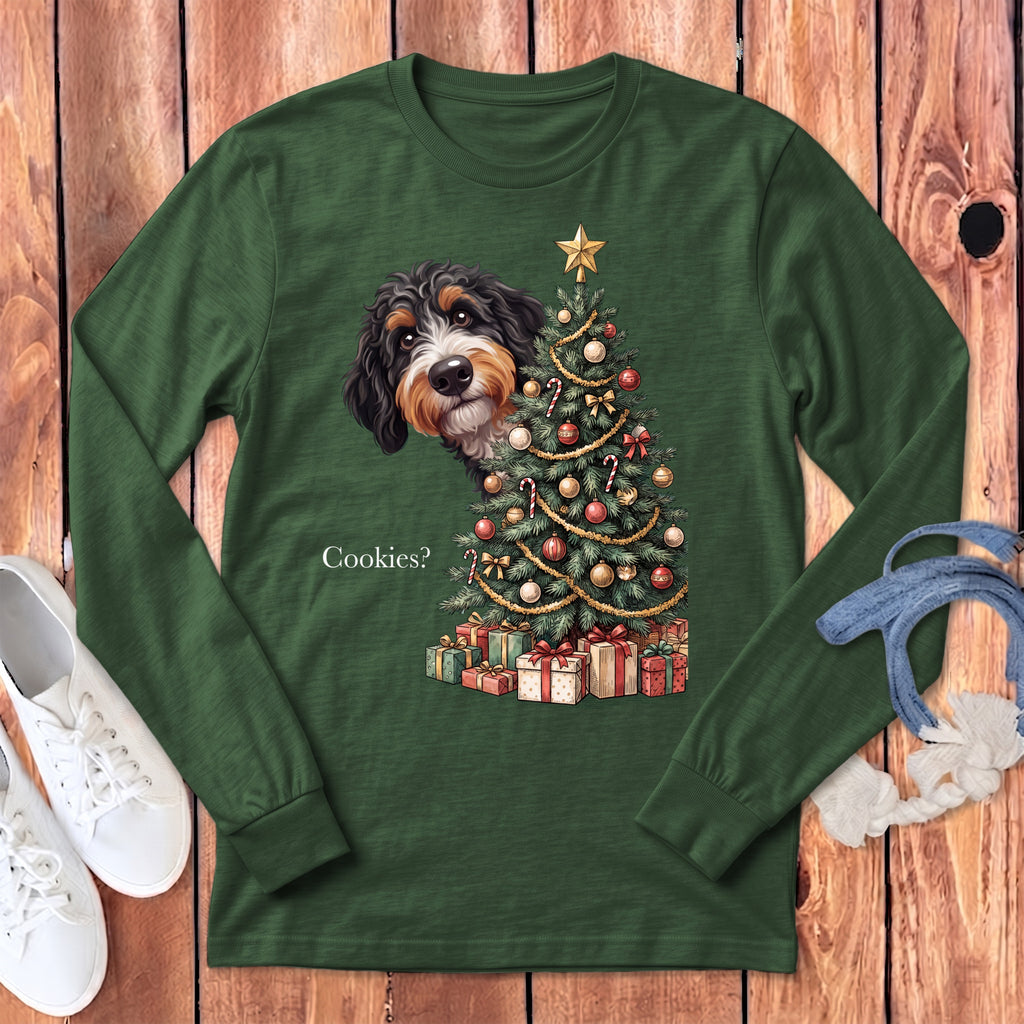 Green long-sleeve shirt with a dog peeking from behind a Christmas tree and gifts.