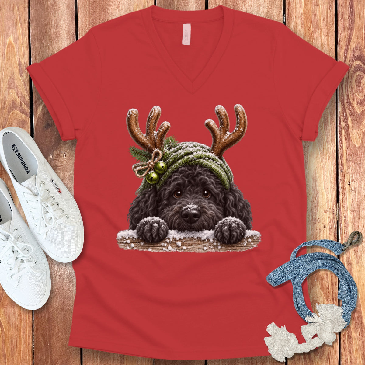 Red v-neck t-shirt with illustration of a black dog wearing reindeer antlers.