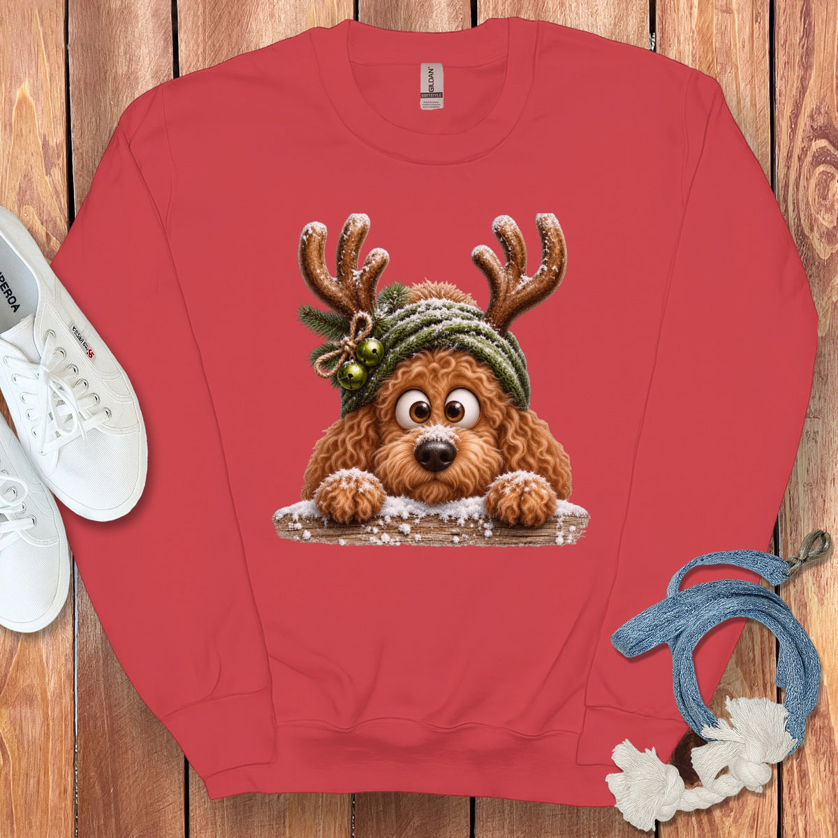 Coral sweatshirt with a cartoon dog wearing reindeer antlers and a beanie.