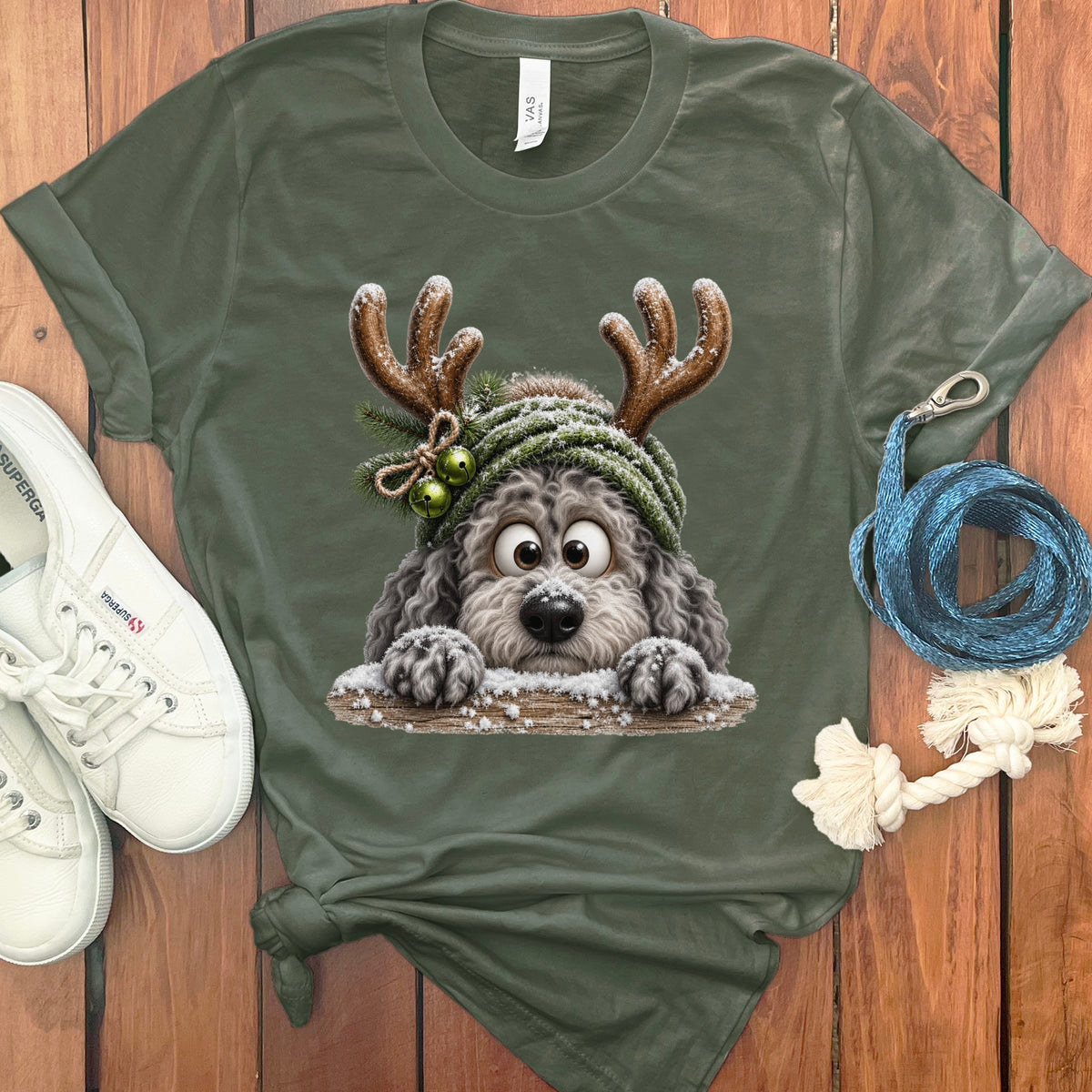 Green t-shirt with a cartoon dog wearing reindeer antlers and a winter hat.