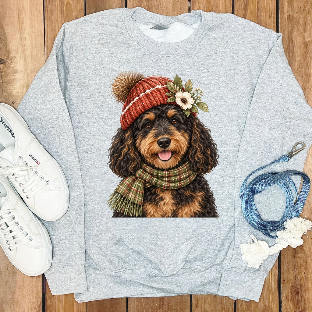 Grey sweatshirt with a Bernedoodle dog graphic wearing a knit hat and scarf.