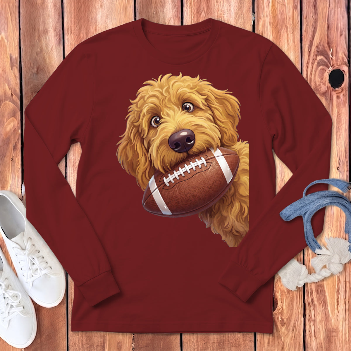 Maroon long sleeve shirt with a golden doodle dog holding a football.