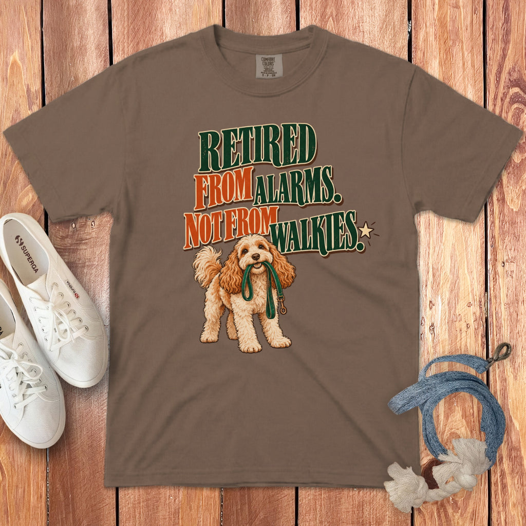 Brown t-shirt featuring the text "Retired from alarms not from walkies" and an illustration of a dog holding a leash.