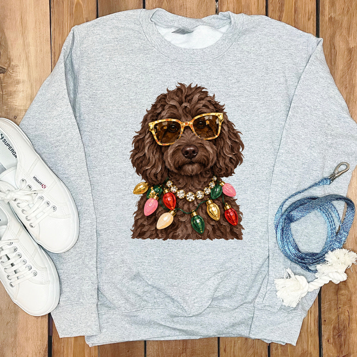 Light gray sweatshirt with a brown dog wearing sunglasses and Christmas lights.