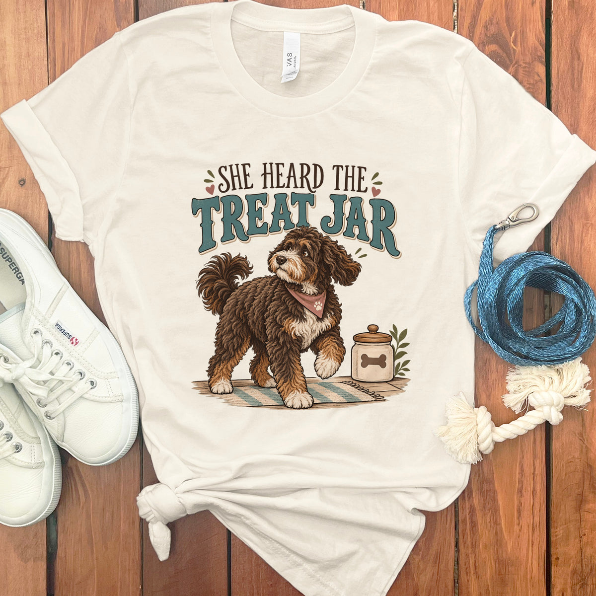 Cream t-shirt with dog and text "She Heard the Treat Jar" graphic.