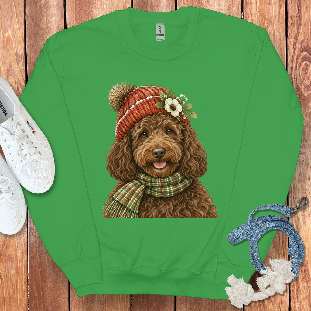 Green sweatshirt with a brown dog wearing a knitted hat and plaid scarf.