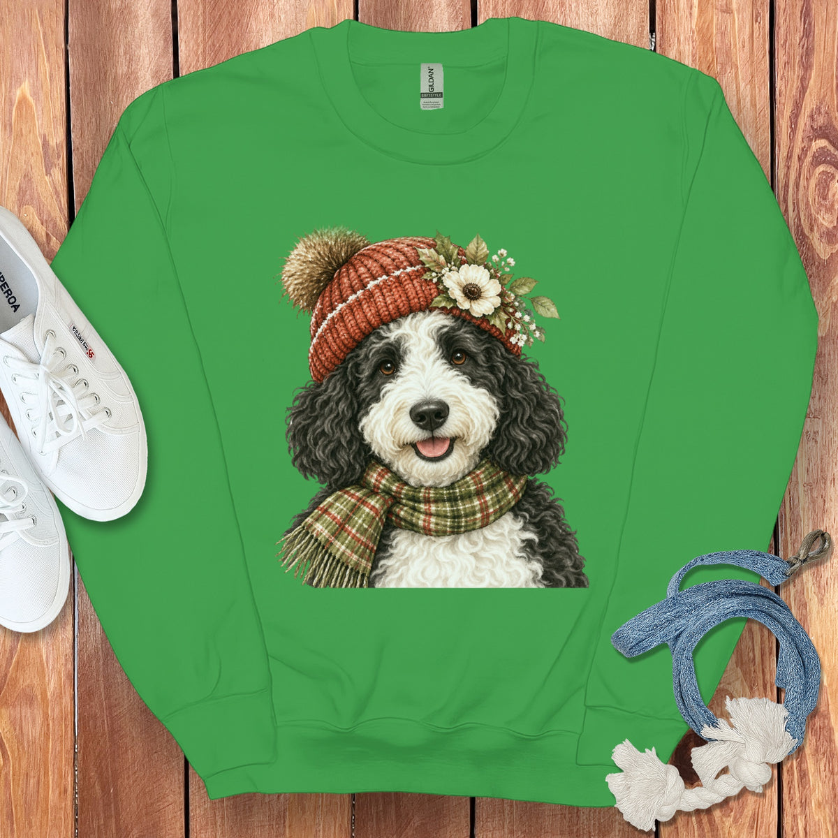 Green sweatshirt with a doodle dog wearing a winter hat and scarf graphic.