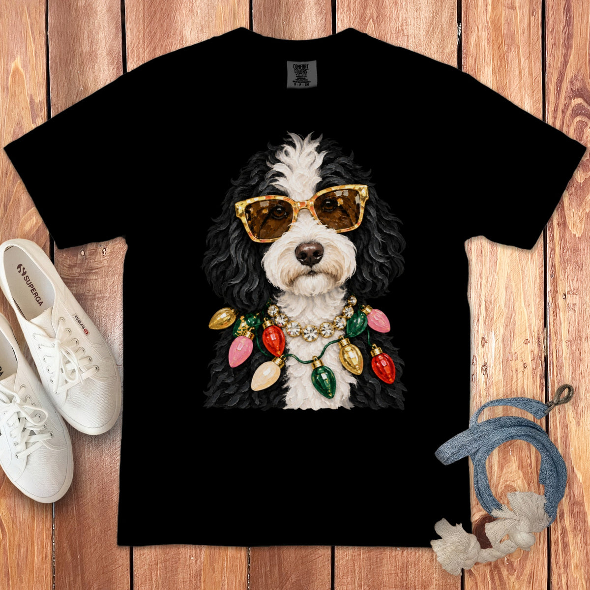 Black t-shirt featuring a dog wearing sunglasses and a Christmas light necklace.