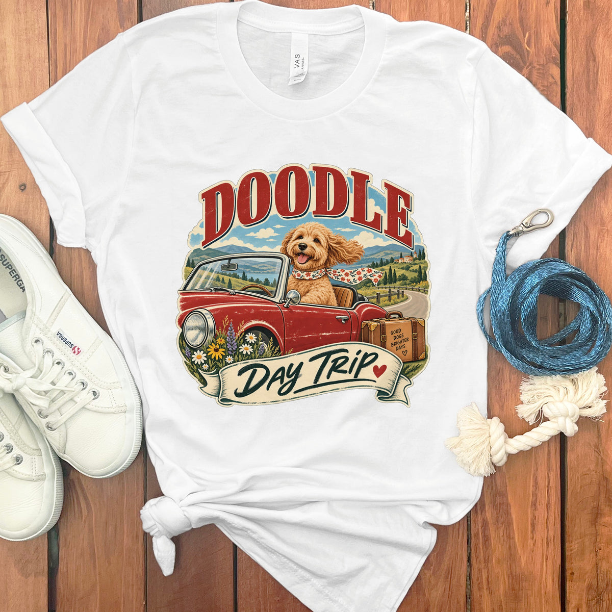White t-shirt with "DOODLE DAY TRIP" text and a dog driving a car.