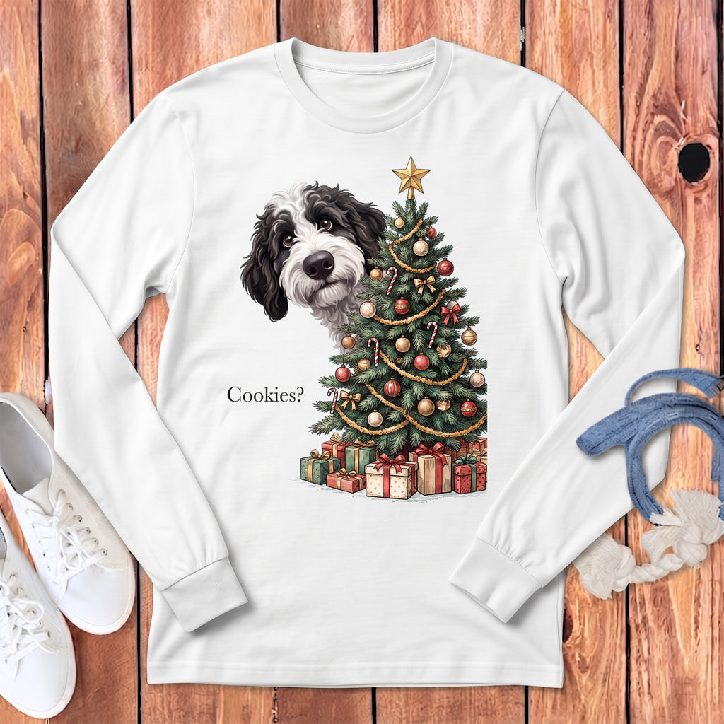 Black and white dog peeking around a decorated Christmas tree with presents and "Cookies?" text.
