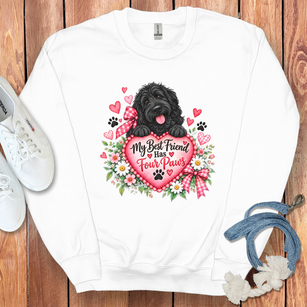 A white crewneck sweatshirt features a graphic of a black dog holding a pink heart reading My Best Friend Has Four Paws.