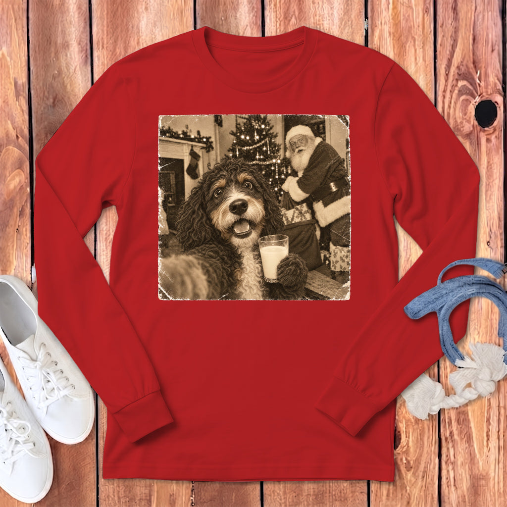 Red long-sleeve t-shirt featuring a black and white graphic of a dog holding a glass of milk with Santa in the background.