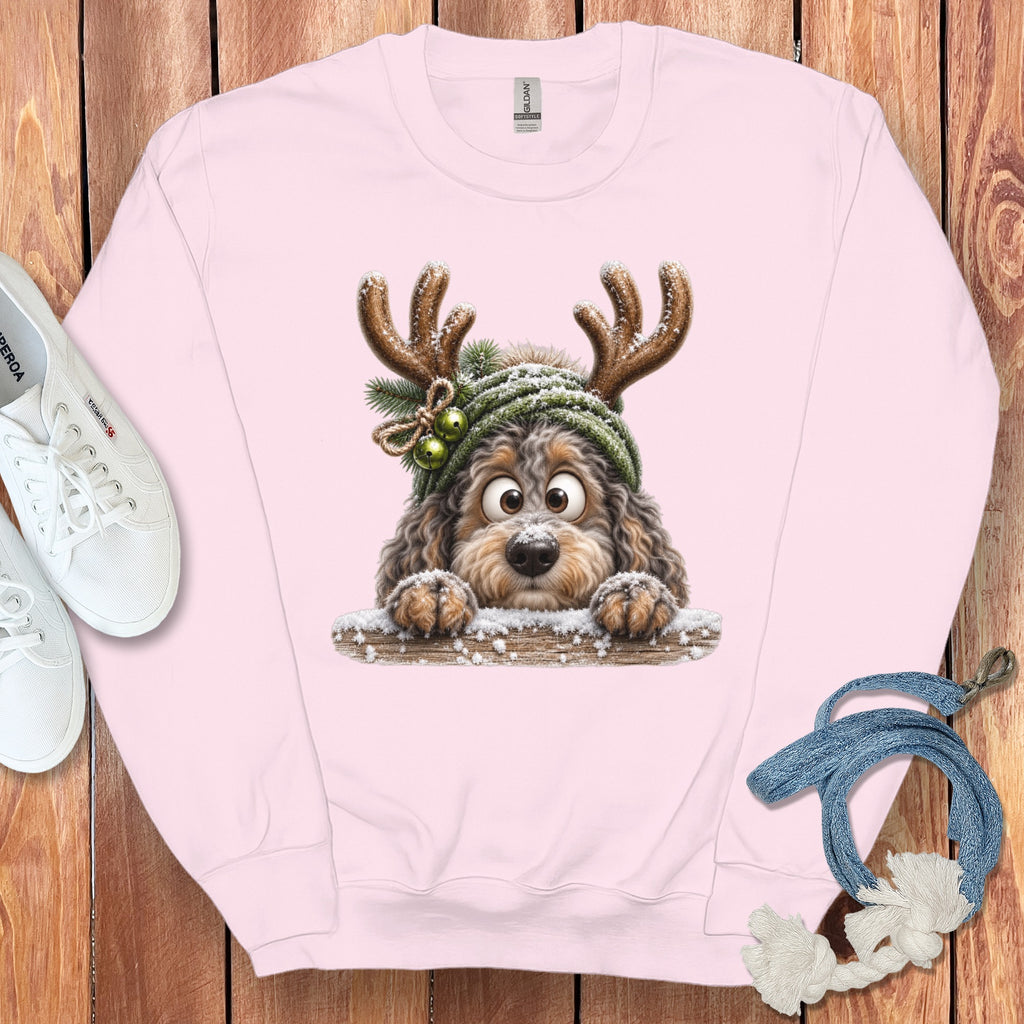 Pink sweatshirt with a cute cartoon dog wearing reindeer antlers and a Santa hat.