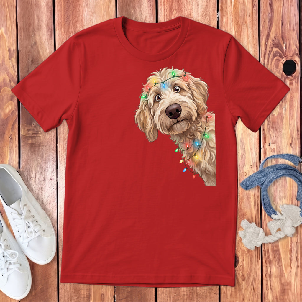 Red t-shirt with a goldendoodle puppy wearing colorful Christmas lights.