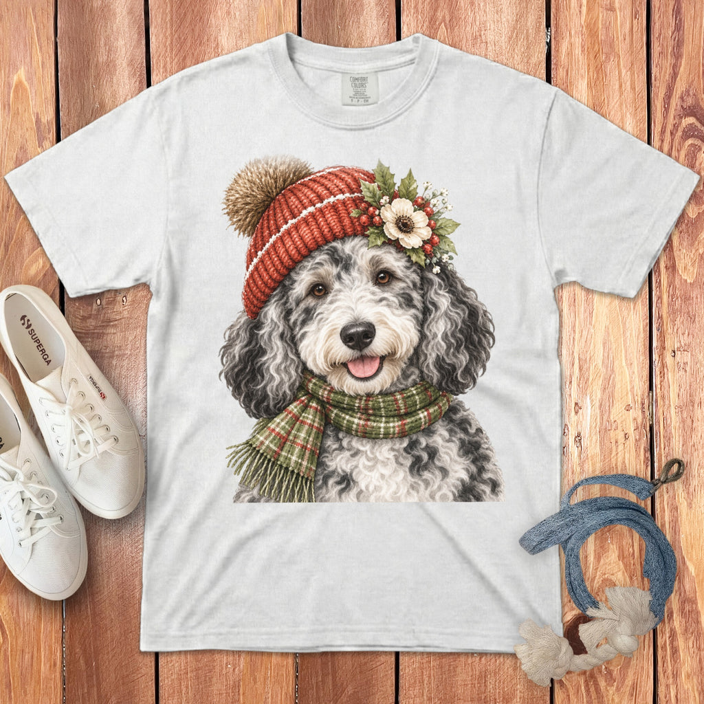 White t-shirt with watercolor doodle wearing red hat, holly, and plaid scarf.
