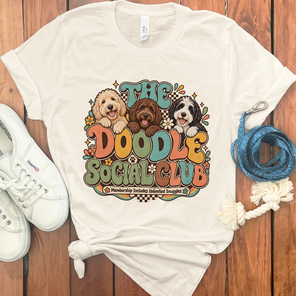 Cream t-shirt with "The Doodle Social Club" graphic featuring three doodle dogs.