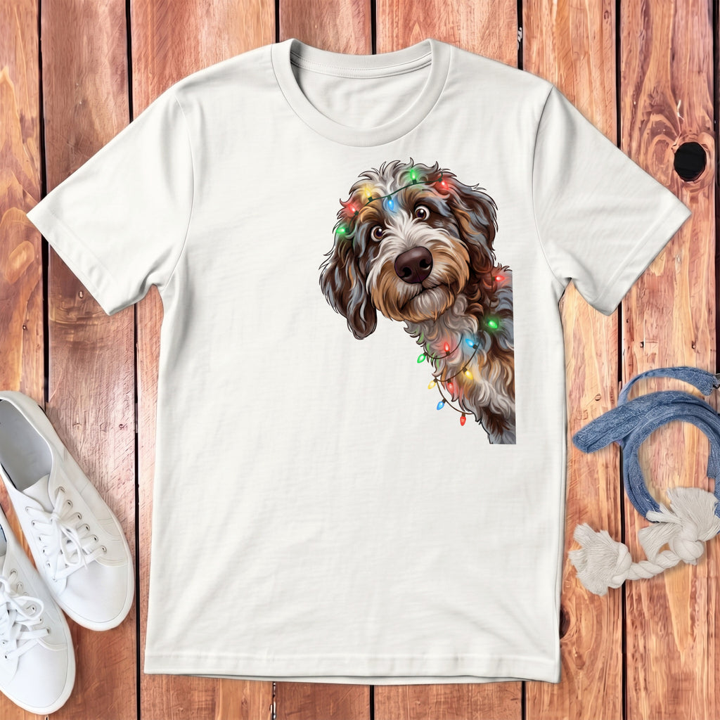 White t-shirt with a doodle dog wearing colorful Christmas lights.