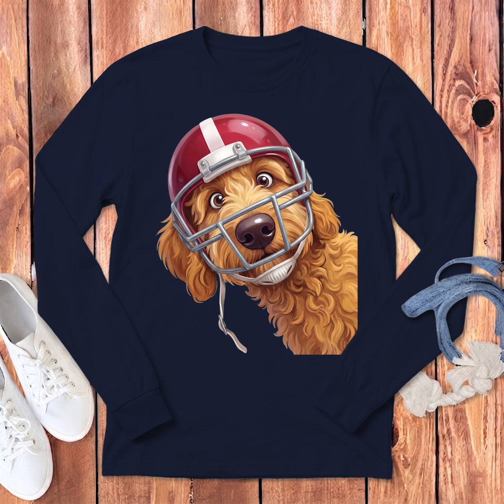 Goldendoodle dog wearing a red and white football helmet on a navy long-sleeve shirt.