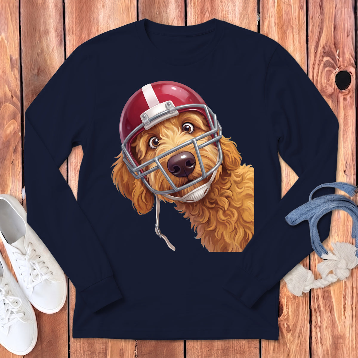 Goldendoodle dog wearing a red and white football helmet on a navy long-sleeve shirt.