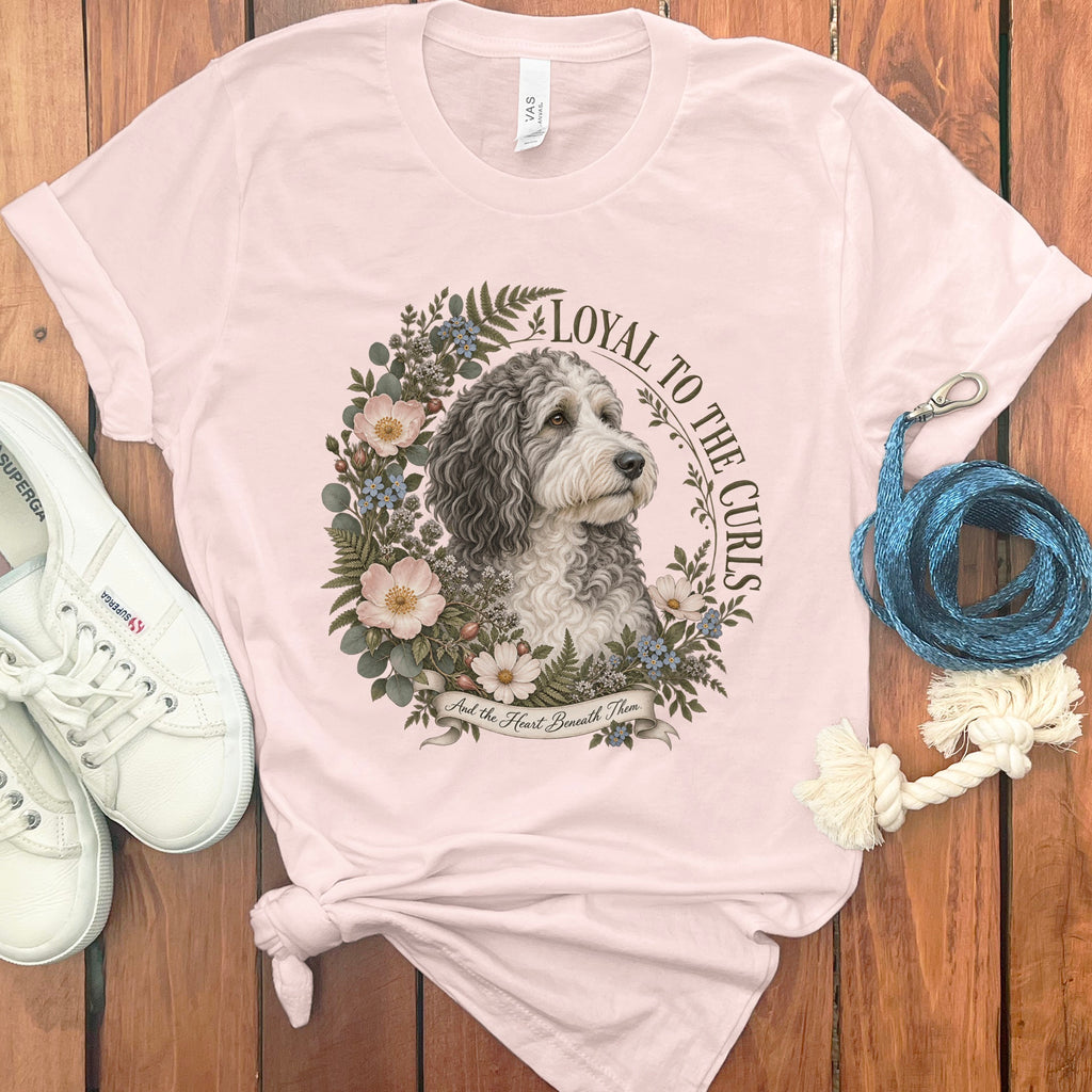 Pink t-shirt with a dog portrait, floral wreath, and text: "Loyal to the Curls."