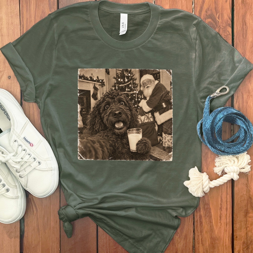 Dark green t-shirt featuring a retro graphic of a doodle dog holding a glass of milk with Santa Claus in the background.