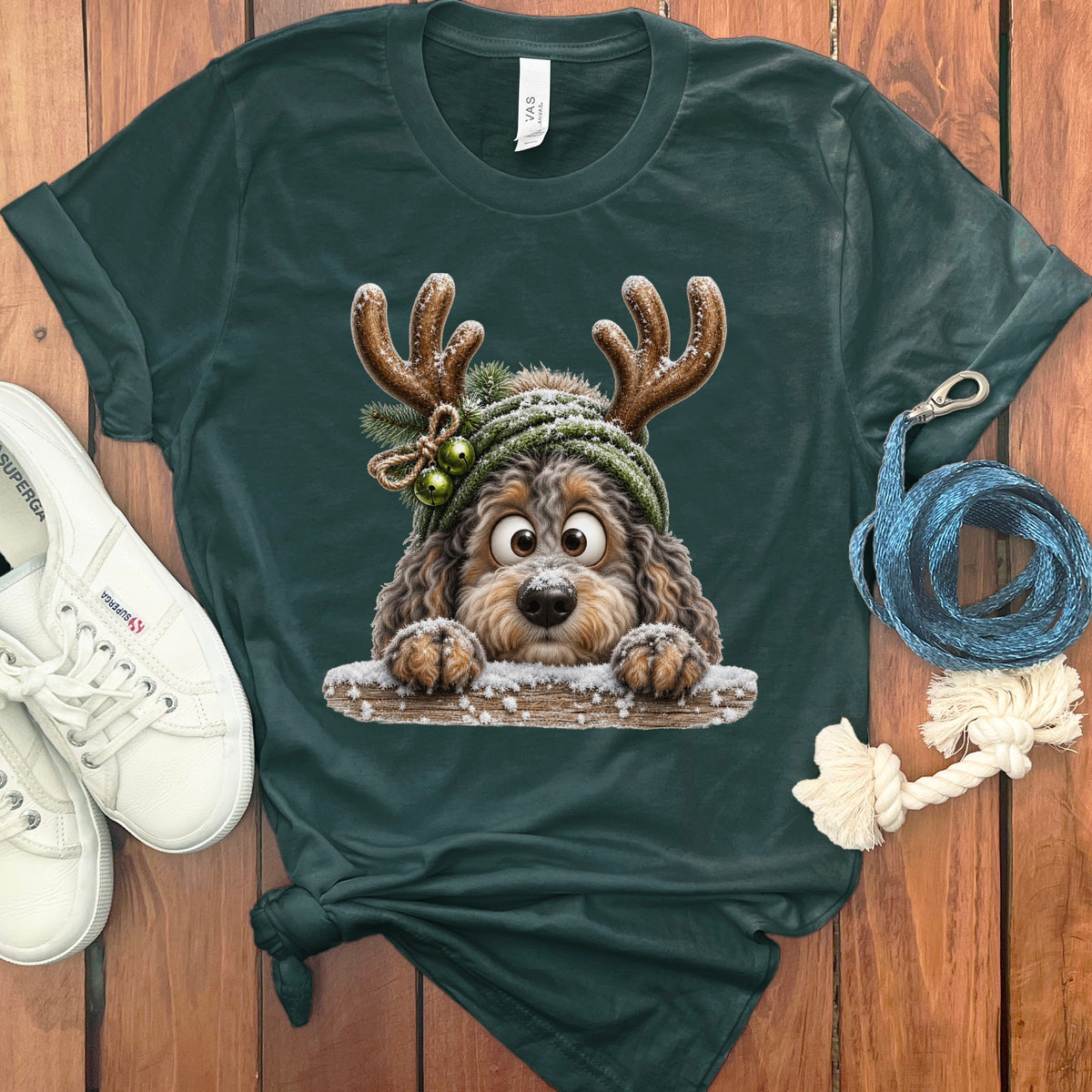 Dark green t-shirt with a cartoon dog wearing reindeer antlers and a hat.