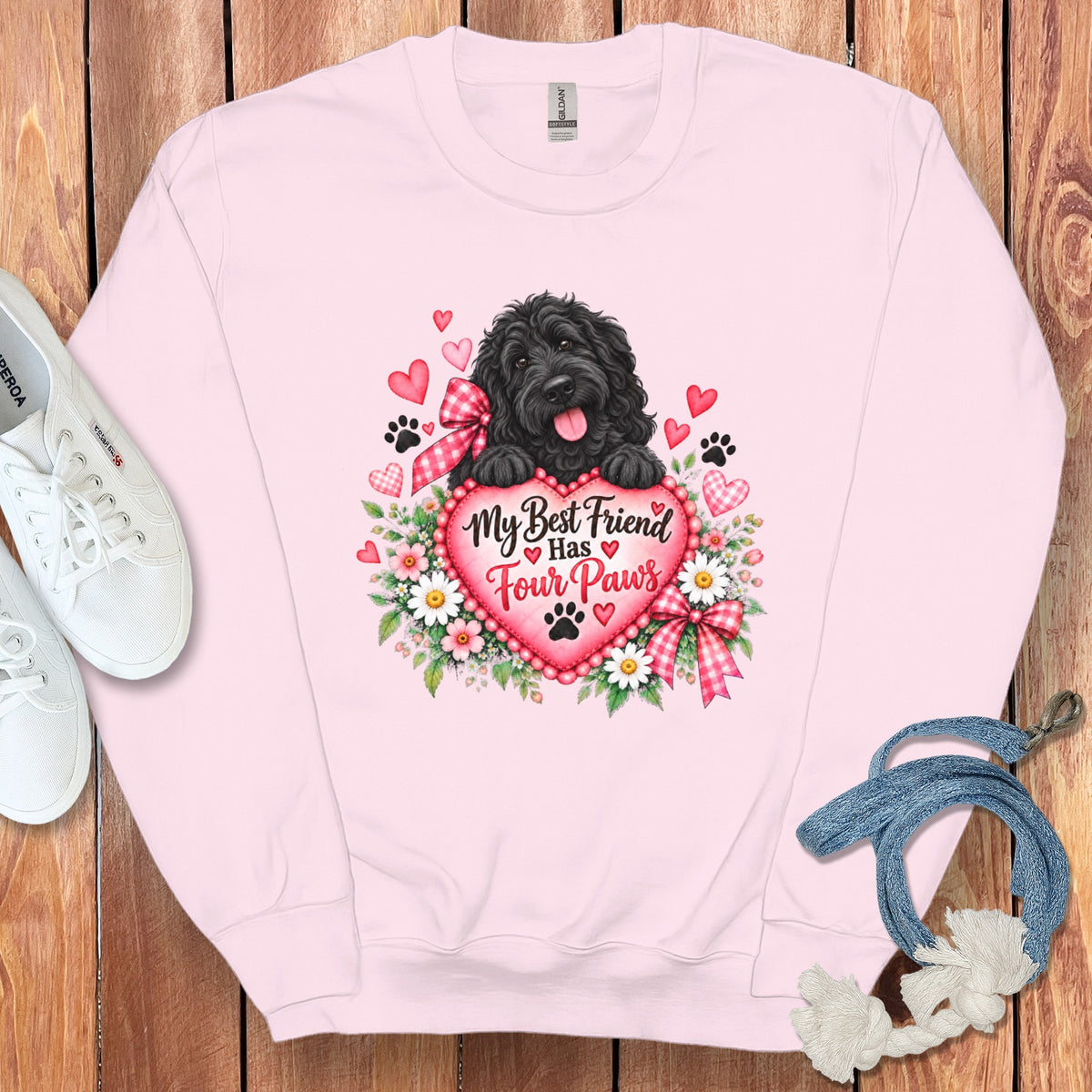 A light pink crewneck sweatshirt features a graphic of a black dog and a heart with the text My Best Friend Has Four Paws.