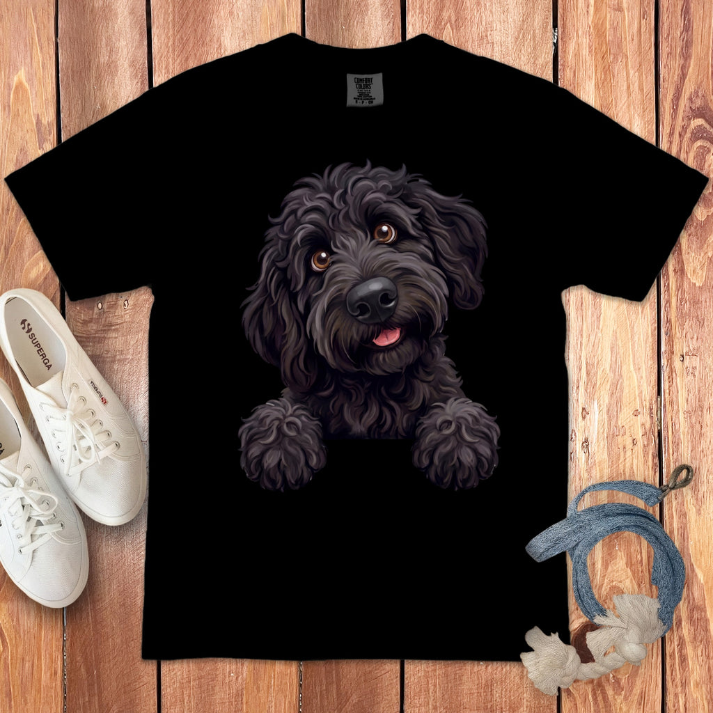 Black t-shirt with a portrait of a fluffy black dog on the front.