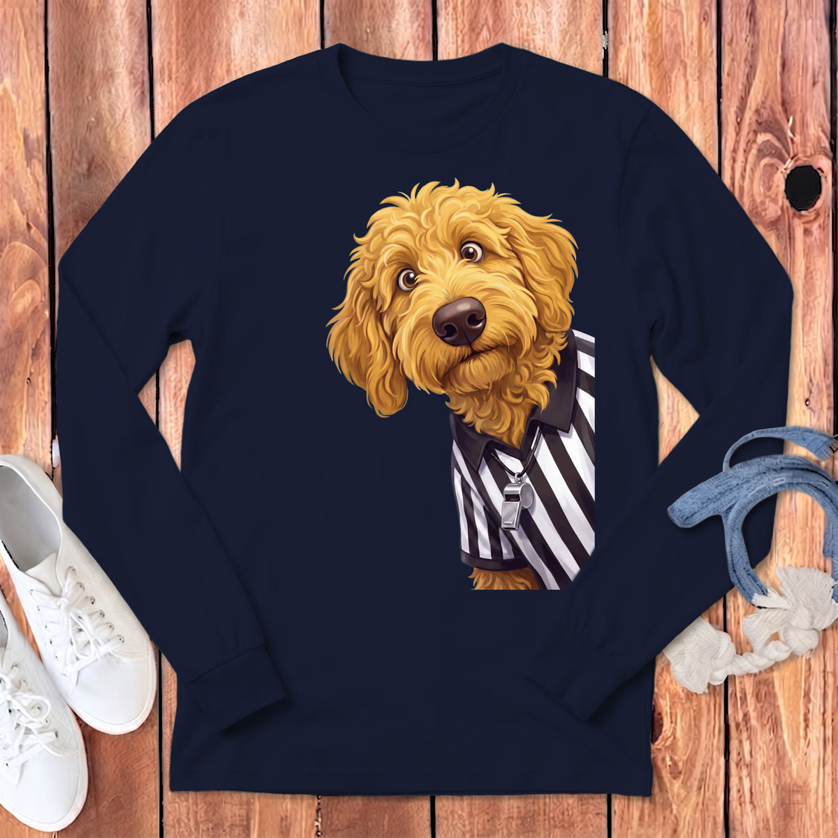 Golden doodle dog wearing a referee shirt with a whistle and lanyard.