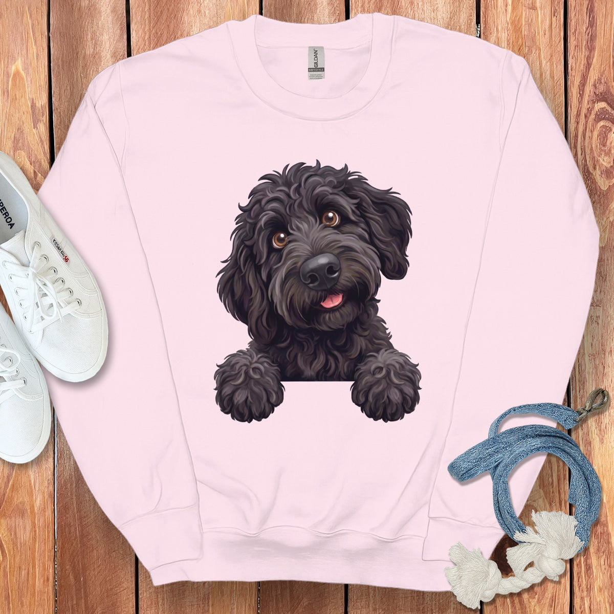 Pink sweatshirt with a black dog graphic and white sneakers.
