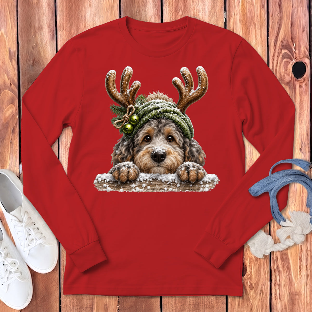 Red long-sleeve shirt with a dog wearing a winter hat and reindeer antlers.