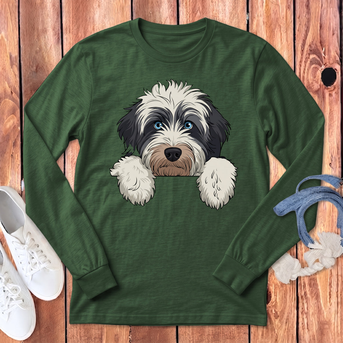 Green long-sleeve shirt with a cartoon dog graphic peeking over the neckline.