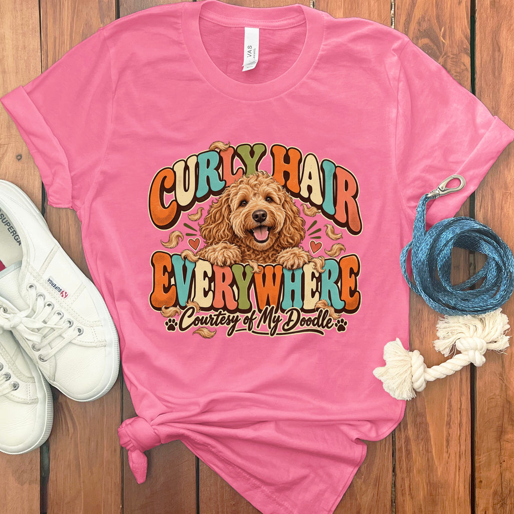 Pink t-shirt with a doodle dog graphic reading "Curly Hair Everywhere, Courtesy of My Doodle."